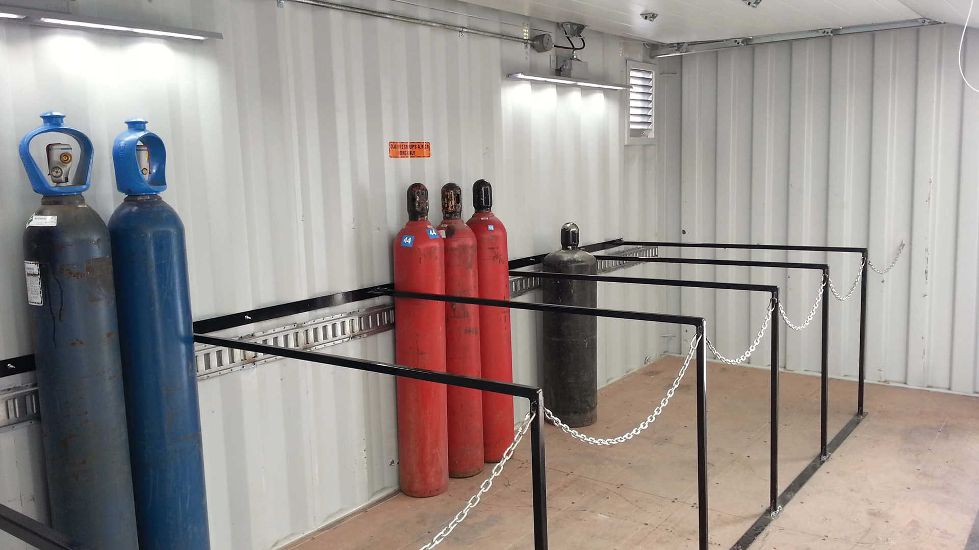 Pressurized cylinders inside of container